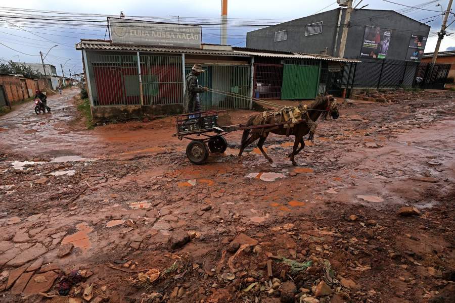 A resident drives his wagon down a street of the Sol Nascente favela of Brasilia, Brazil, Monday, March 20, 2023. Sol Nascente, which means Rising Sun, is now Brazil's most populous, and has unpaved, impassable roads, which flood frequently during the months of summer rains