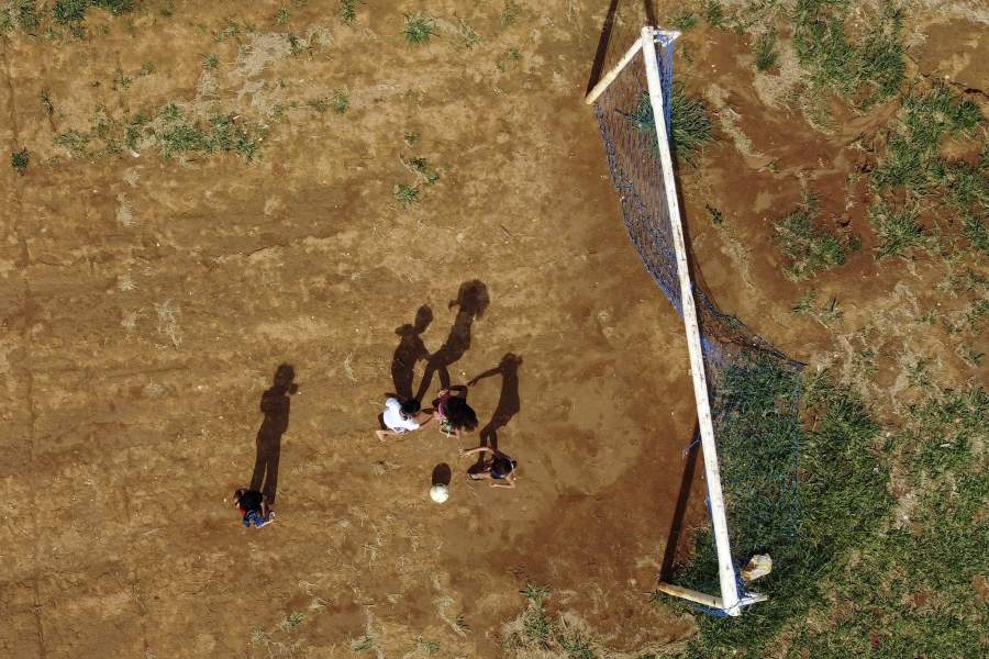 An aerial view of children playing soccer in one of the poorest sectors of the Sol Nascente favela of Brasilia, Brazil, Wednesday, March 22, 2023. The growth of Sol Nascente, which means Rising Sun, reflects people moving here in search of cheap or unoccupied land to build homes, whereas elsewhere in the Federal District poor people often pay relatively high rents. 