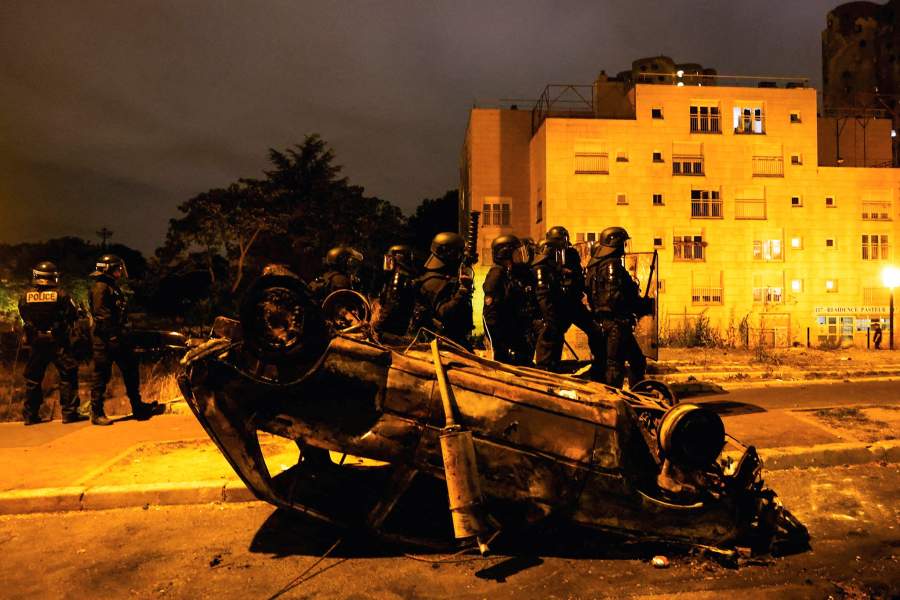 French police stand in position during clashes with protesters, following the death of Nahel, a 17-year-old teenager killed by a French police officer during a traffic stop, in Nanterre, Paris suburb, France, June 30, 2023.