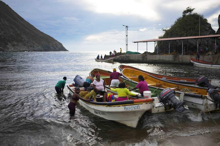 Рыбачки прибывают на берег после дня рыбалки в Чуао, Венесуэла. Вторник, 6 июня 2023 г. Некоторые женщины присоединяются к семейной традиции рыбалки, а в других случаях начинают новую карьеру после потери работы во время экономического кризиса Венесуэлы
