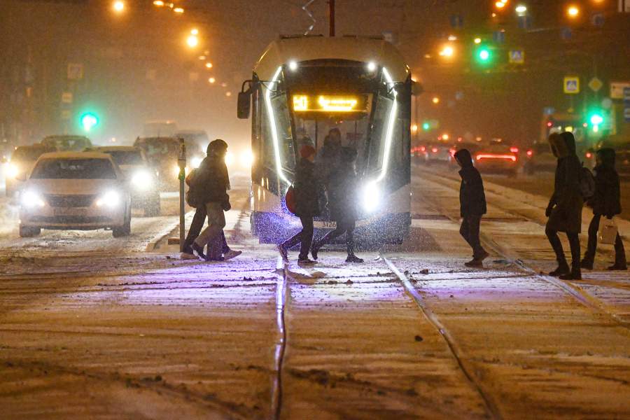 Прохожие переходят дорогу во время сильного снегопада в Москве