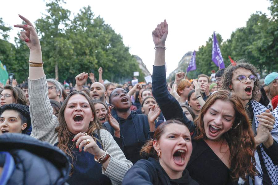 People react at the Place de la Republique after partial results in the second round of the early French parliamentary elections, in Paris, France, July 7, 202