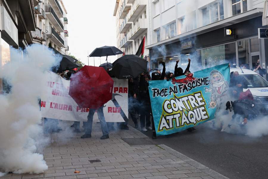 A statue is seen among tear gas following clashes during a demonstration after partial results in the second round of the early French parliamentary elections, in Nantes, France, July 7, 2024