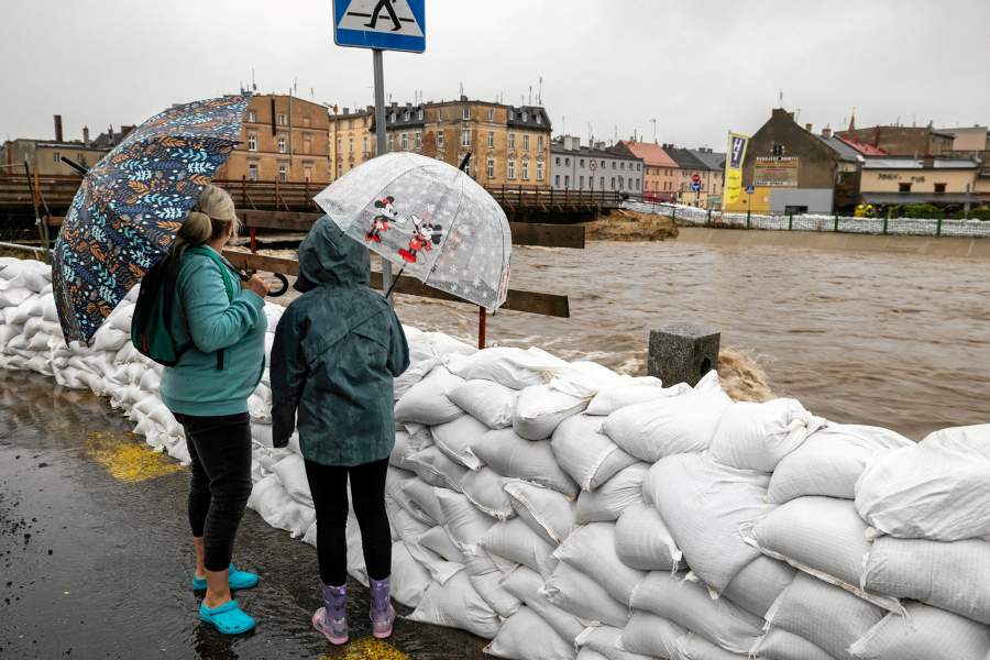 People watch Bialka river following heavy rainfalls in Glucholazy, Poland