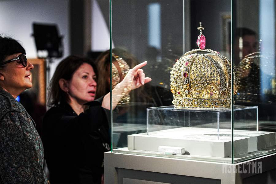 14 ноября 2024. Россия. Москва. Посетители на выставке «Наследие Петра Великого и дворцовые перевороты в Российской империи». Экспонат: корона императрицы Анны Иоанновны