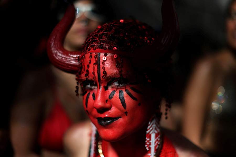 A reveller takes part in the "Cordao de Boitata" block party during a pre-Carnival parade in Rio de Janeiro