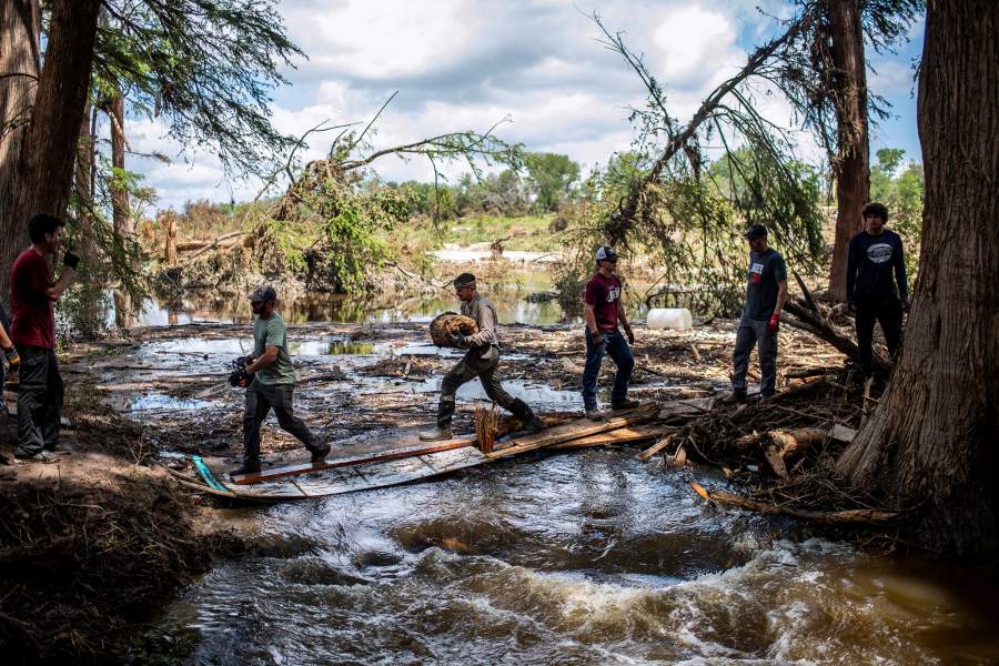 Volunteers work to clear the area around the Guadalupe River near Camp Camp after catastrophic floods in Center Point, Texas, U.S., July 11, 2025