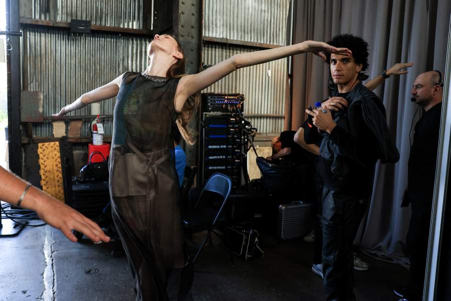 A model enjoys a breeze on a warm fall day backstage at the Jason Wu show before presenting creations during New York Fashion Week in New York City, U.S., September 14, 2025. REUTERS/Caitlin Ochs
