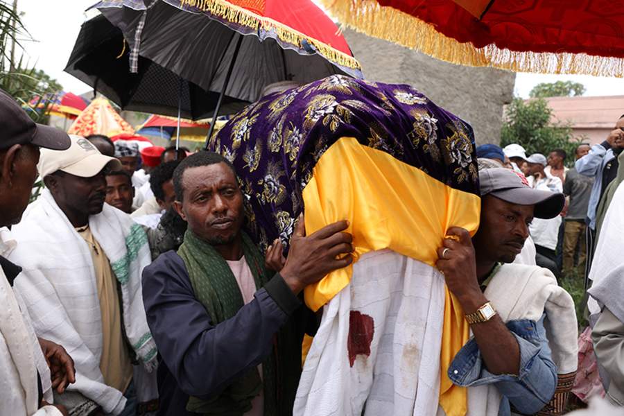 Pallbearers carry coffins of victims of a wooden scaffolding collapse at the St. Mary Orthodox Church that killed faithful during the funeral ceremony in Arerti, Ethiopia