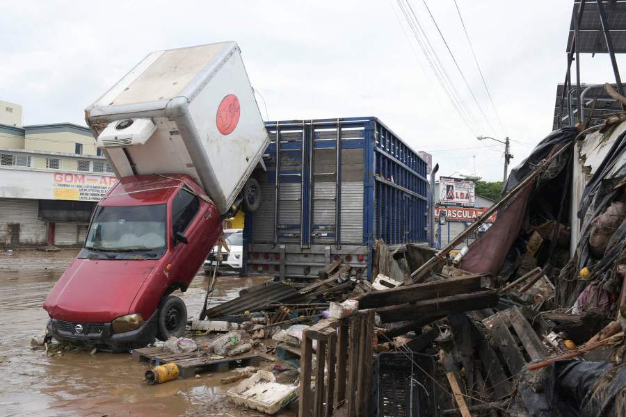 A damaged car swept away by rainwaters after torrential rains overflowed rivers, causing flooding in Poza Rica, Veracruz state, Mexico, October 11, 2025. 