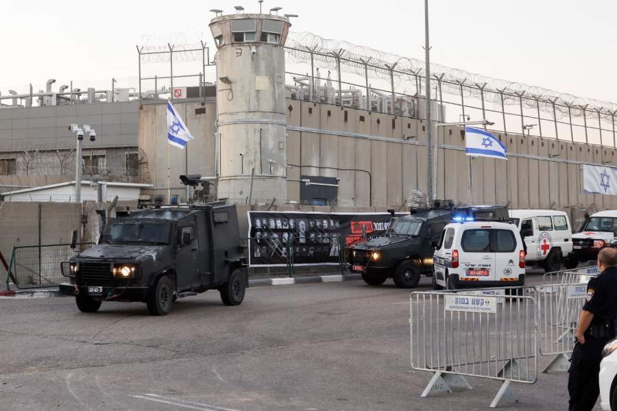 Vehicles move outside the Israeli military prison, Ofer, on the day Israel is expected to release Palestinian prisoners as part of a hostages-prisoners swap and a ceasefire deal in Gaza between Hamas and Israel, near Ramallah, in the Israeli-occupied West Bank, October 13, 2025