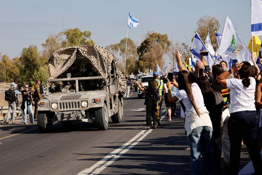 A convoy carrying released hostages, who have been held in Gaza since the deadly October 7, 2023 attack by Hamas, released as part of a prisoner-hostage swap and a ceasefire deal between Israel and Hamas, arrive in Reim, southern Israel, October 13, 2025