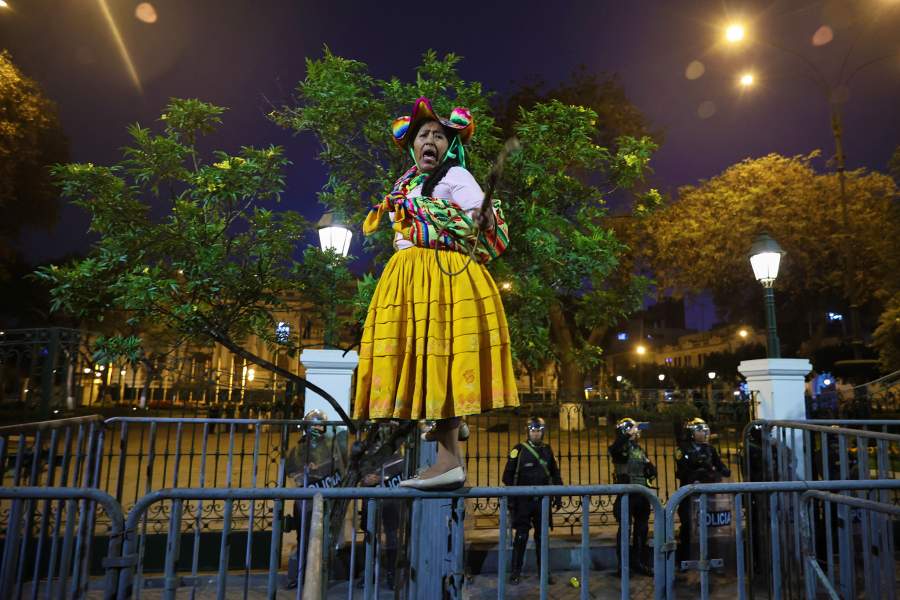 An indigenous woman stands on a metal barricade during a protest against rising crime, economic insecurity, and corruption, a day after President Jose Jeri presented his cabinet, in Lima, Peru, October 15, 2025. REUTERS/Sebastian Castaneda