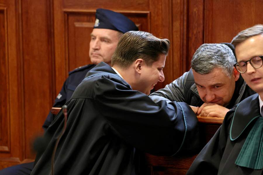 Ukrainian diver Volodymyr Zhuravlov, who is wanted by Germany over his alleged involvement in the 2022 explosions that damaged the Nord Stream pipeline and severely disrupted Russian gas supplies to Europe, speaks with his lawyer Tymoteusz Paprocki as a judge rules to deny Germany's extradition request and lift his pretrial detention, at the district court in Warsaw, Poland, October 17, 2025.