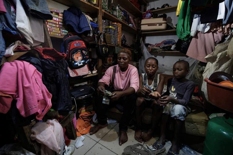 Acceline Ngouana, 36, a trained nurse who left the profession due to meager pay, counts her earnings after finishing work as a motorcycle taxi rider as she sits at the back of her workshop where she lives with her daughters in Douala, Cameroon, October 4, 2025. Ngouana now works as a motorcycle taxi rider while running a small garage as a single mother of three. "I hope for change, and I will vote for change." she said, without didn’t specify which challenger she would back