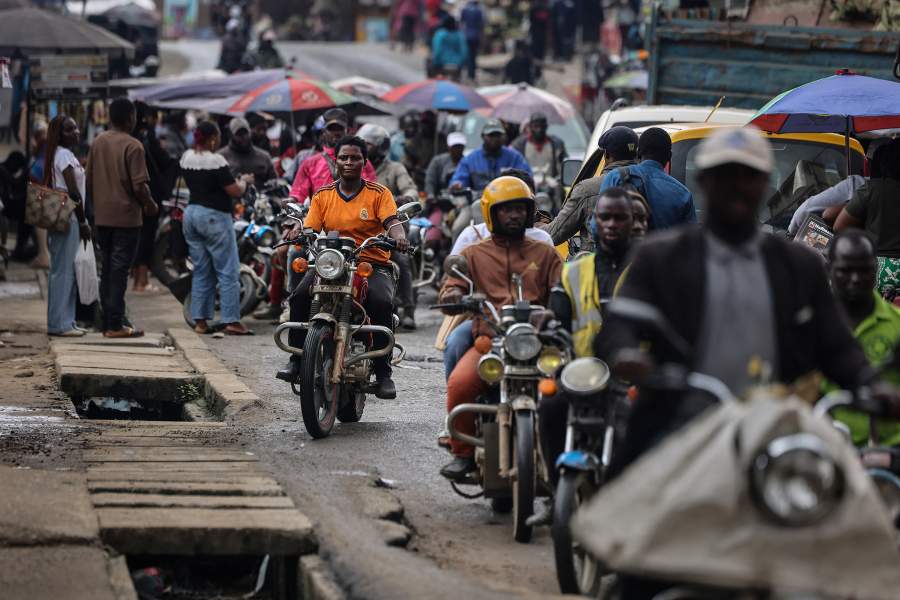 Acceline Ngouana, 36, a trained nurse who left the profession due to meager pay, rides a motorcycle to test it after fixing its chain, near her workshop in Douala, Cameroon, October 3, 2025. Ngouana now juggles Mototaxi riding or "Benskin" with running a 