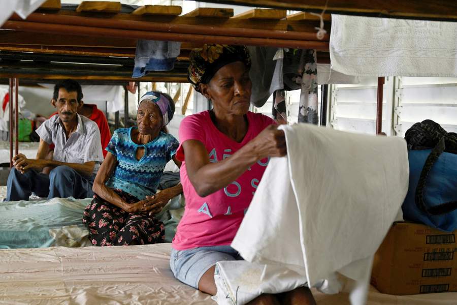 People rest in a shelter where they were moved as a precautionary measure as people prepare for the arrival of Hurricane Melissa, in Santiago de Cuba, Cuba