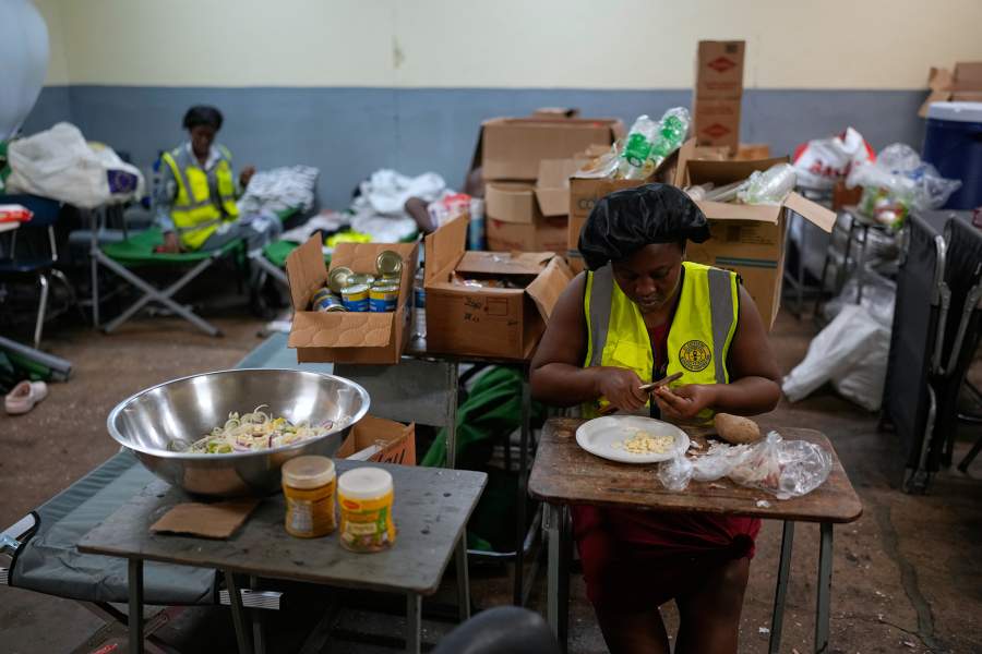 Cooks prepare meals at a shelter set up in a school ahead of Hurricane Melissa's forecast arrival in Old Harbour, Jamaica