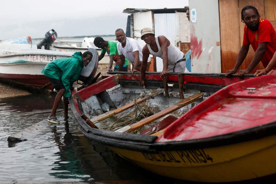 Fishermen move a boat to higher ground, in preparation of Hurricane Melissa, in Port Royal, Jamaica