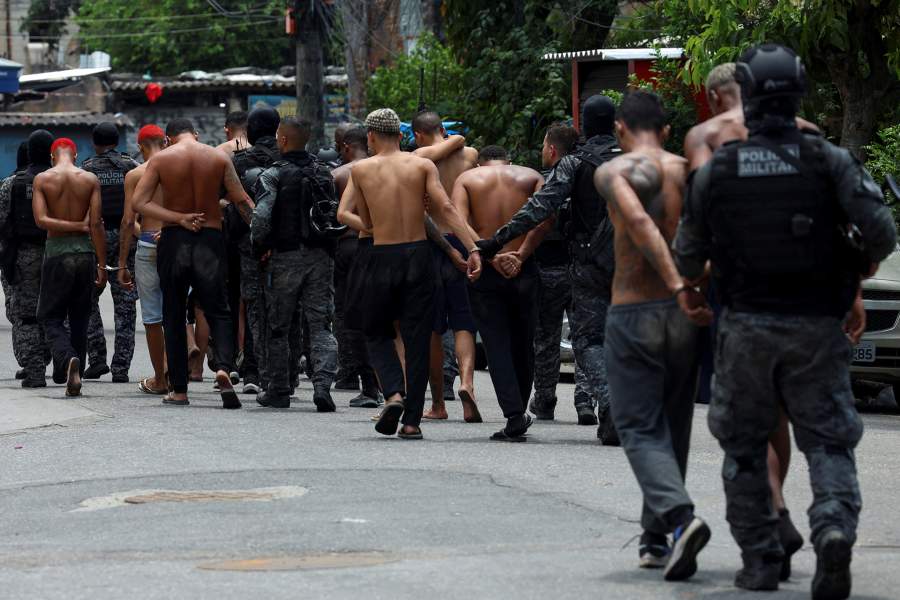Members of the military police special unit detain suspected drug dealers during a police operation against drug trafficking at the favela do Penha, in Rio de Janeiro, Brazil October 28, 2025