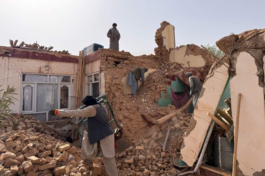 Locals search among the rubble of a destroyed house after a 6.3 powerful in a rural area of the Khulm District, Samangan Province, northern Afghanistan