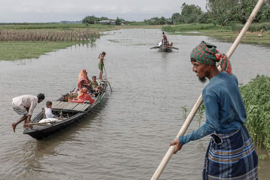 Relatives of Kosim Uddin, 50, travel by boat with belongings as they relocate to another island in the Brahmaputra River, with their current one on the verge of being destroyed by erosion, in Kurigram, Bangladesh, June 20, 2024. REUTERS/Mohammad Ponir Hossain
