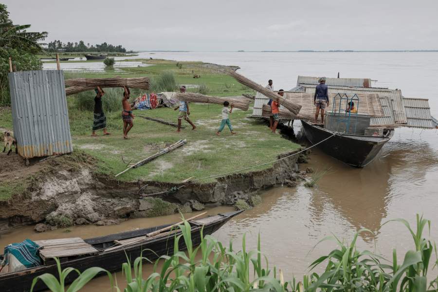 Relatives and neighbours help move the house of Kosim Uddin, 50, to another island in the Brahmaputra River, as the current one is on the verge of being destroyed by erosion, in Kurigram, Bangladesh, June 20, 2024. REUTERS/Mohammad Ponir Hossain