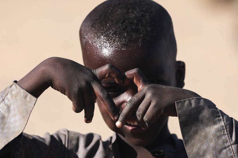 A Sudanese refugee boy from al-Fashir gestures at the Tine transit camp, amid the conflict between the paramilitary Rapid Support Forces (RSF) and the Sudanese army, in eastern Chad, November 23, 2025. REUTERS/Amr Abdallah Dalsh