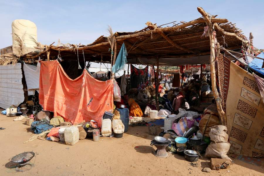 FILE PHOTO: Sudanese women who fled intense fighting in al-Fashir sit in a tent made of straw and tree branches at a displacement camp, as the humanitarian situation deteriorates amid the ongoing conflict between the paramilitary Rapid Support Forces (RSF) and the Sudanese army, in Al Dabba, Sudan, September 6, 2025. REUTERS/El Tayeb Siddig/File Photo