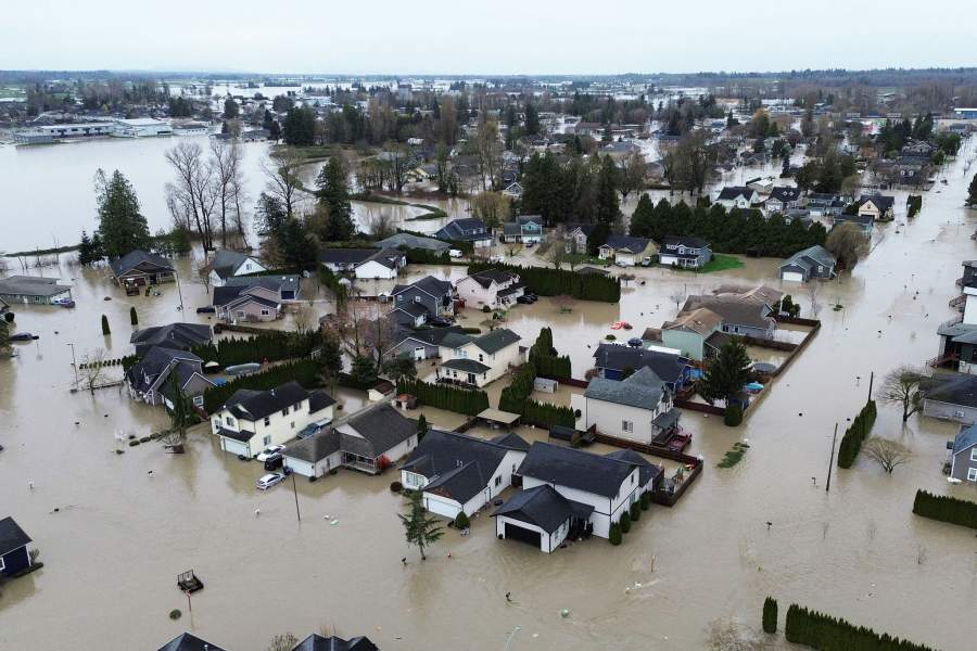 A drone picture shows floodwaters inundating houses in the town of Sumas, Washington, as seen from the Canadian side of the border after an atmospheric river caused heavy rains across the region and triggered evacuation alerts in Abbotsford and Chilliwack, in Abbotsford, British Columbia, Canada, December 11, 2025