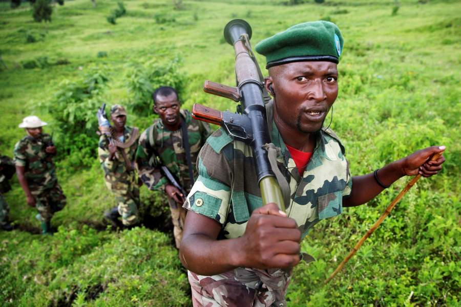 M23 rebel fighters walk as they withdraw near the town of Sake, some 42 km (26 miles) west of Goma, Democratic Republic of Congo, November 30, 2012. REUTERS/Goran Tomasevic/File Photo