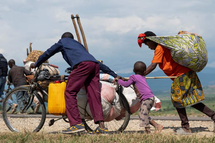 Congolese people displaced during renewed clashes between Alliance Fleuve Congo AFC/M23 and the Armed Forces of the Democratic Republic of the Congo (FARDC), walk back to their homes from Sange, in Luvungi, a settlement north of Uvira, South Kivu province, in the Democratic Republic of Congo, December 13, 2025. REUTERS/Stringer