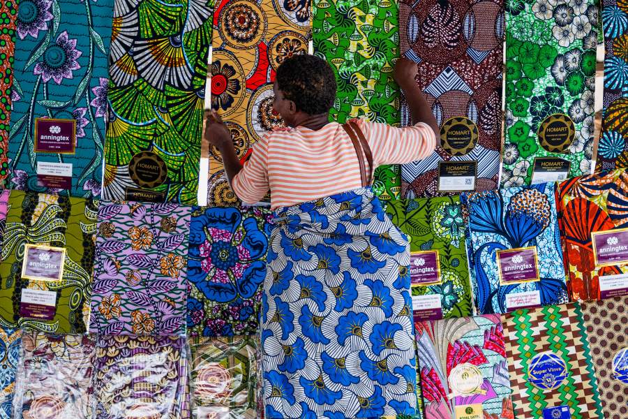 A Congolese trader arranges fabric for sale at Maendeleo market as calm returns after clashes between members of the Alliance Fleuve Congo 