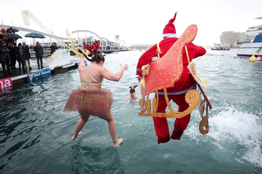People wearing Christmas-themed costumes jump into the Mediterranean Sea during the Copa Nadal (Christmas Cup) swimming race in Barcelona, Spain December 25, 2025. REUTERS/ Bruna Casas