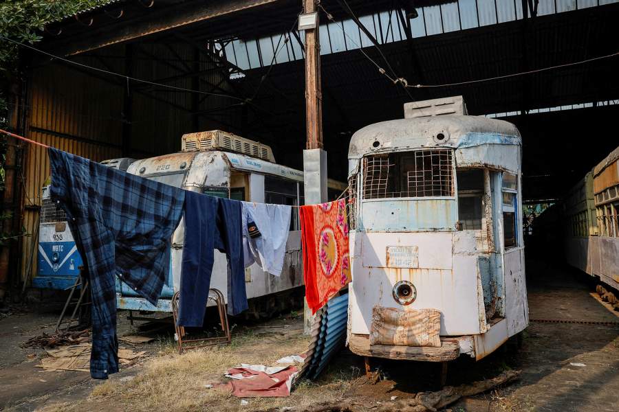 Clothes hang to dry from a rope tied to an on old defunct tram inside a tram depot in Kolkata, India, November 21, 2024. REUTERS/Sahiba Chawdhary TPX IMAGES OF THE DAY