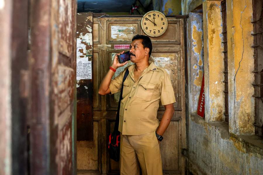Bacchu Sidda, 56, a tram conductor, talks on the phone while he stands inside the Shyambazar Tram Terminus office in Kolkata, India, February 24, 2025. REUTERS/Sahiba Chawdhary