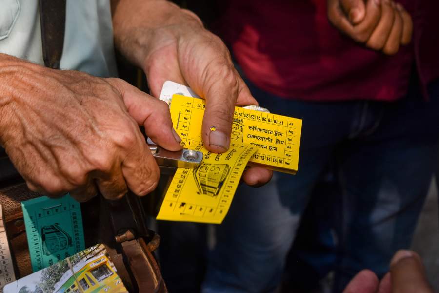 Robert D'Andrea , an ex tram conductor from Melbourne is seen showing a replica ticket of Kolkata tram services , during 150 year celebration of Tram services in Kolkata , India , on 24 February 2023 . Citizens and various organization came together to celebrate 150 years of Tram services in Kolkata , India , with the theme of preserving heritage and promoting green mobility with use of Tram in the city , which is in the verge of extinction due to progres