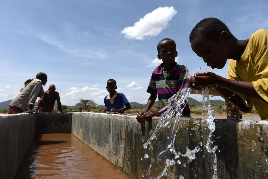 Children drink water from a pipeline in the village of Afraaga, Somaliland where charity CARE International have built a storage tank and installed pipelines and taps to give villagers access to clean water from a nearby borehole. (Photo by Joe Giddens/PA Images via Getty Images)
