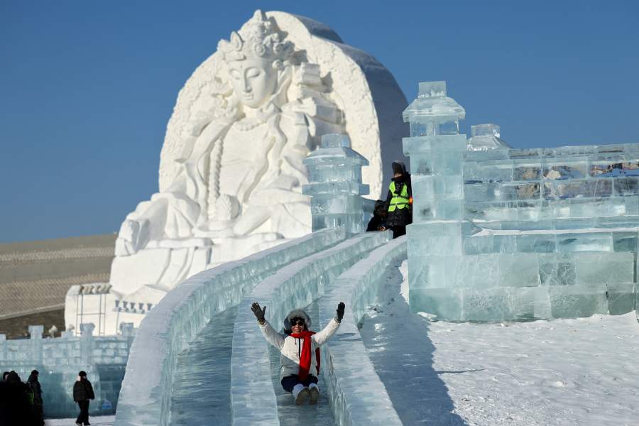 A person slides down an ice slide at the annual Ice and Snow Festival in Harbin, Heilongjiang Province, China, January 4, 2026