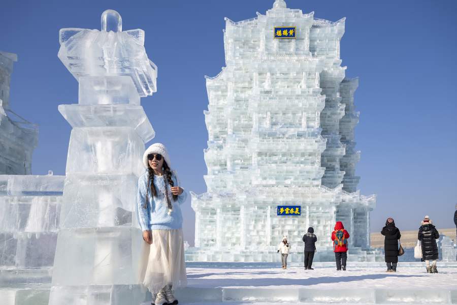 HARBIN, CHINA - DECEMBER 17: Tourists visit the 27th Harbin Ice and Snow World on December 17, 2025 in Harbin, Heilongjiang Province of China. The world's largest ice-and-snow theme park, the 27th edition of the Harbin Ice-Snow World, officially opened at 10 a.m. on December 17 in Harbin, the capital city of northeast China's Heilongjiang Province