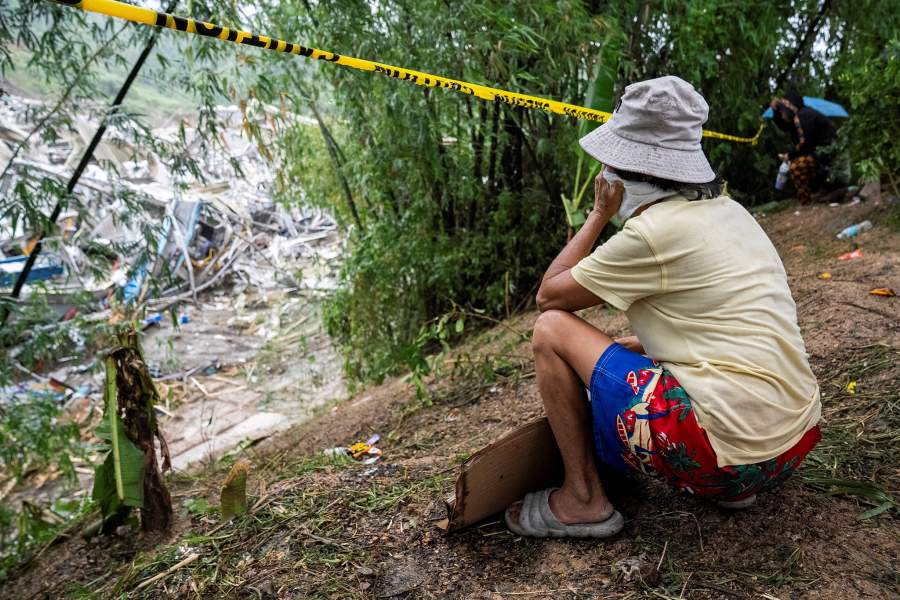 A woman watches as workers conduct a rescue operation at the collapsed landfill in Binaliw, Cebu, Philippines, January 10, 2026. REUTERS/Lisa Marie David