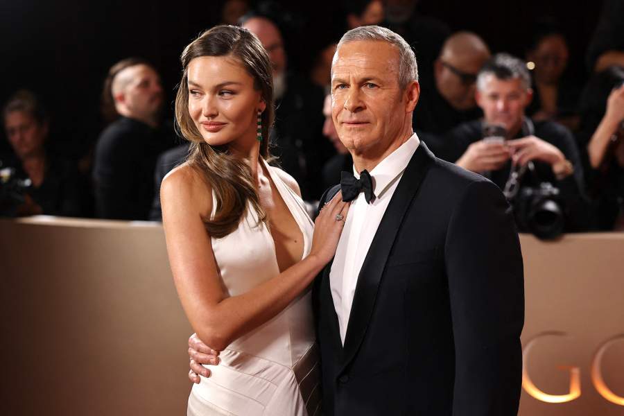 Kristina Romanova and Vladislav Doronin pose on the red carpet at the 83rd Annual Golden Globes in Beverly Hills