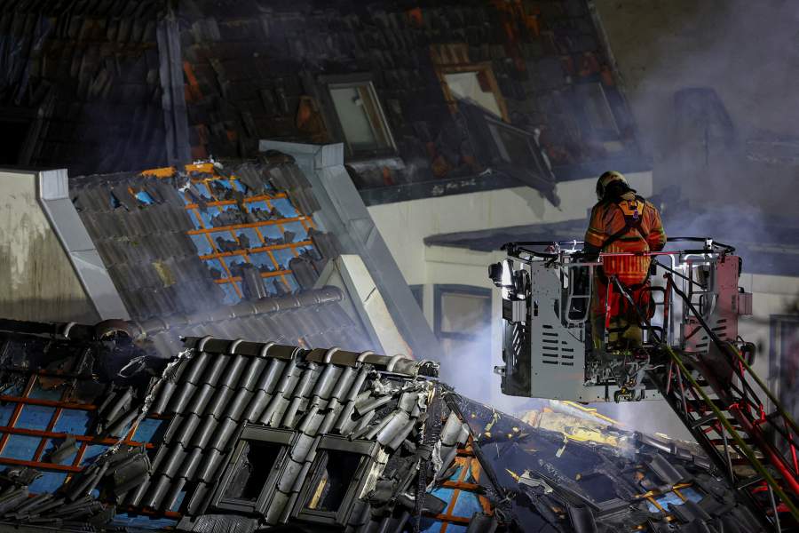 A firefighter works at the site of a large fire that broke out following an explosion, in Utrecht, Netherlands, January 15, 2026