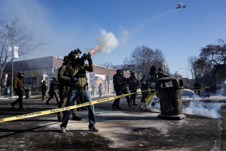A federal agent shoots tear gas cannisters during scuffles at the scene of a shooting involving federal immigration agents in Minneapolis, Minnesota, U.S., January 24, 2026.