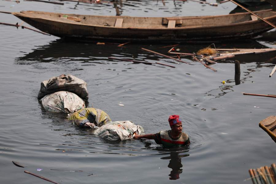 A person wades through the floating Makoko slum as authorities continue to demolish stilt houses in the Makoko riverine community in Lagos, Nigeria, January 25, 2026. Officials are removing structures, including homes and schools, near power lines, in a wider push to recover lagoon-side land from the historic fishing community often called the "Venice of Nigeria." REUTERS/Sodiq Adelakun