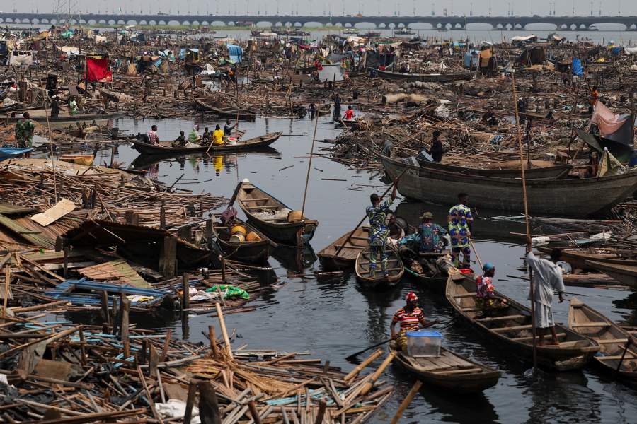 People evacuate, as authorities burn leftover structures in the Makoko riverine community in Lagos, Nigeria, January 25, 2026. Officials are removing structures, including homes and schools, near power lines, in a wider push to recover lagoon-side land from the historic fishing community often called the "Venice of Nigeria." REUTERS/Sodiq Adelakun
