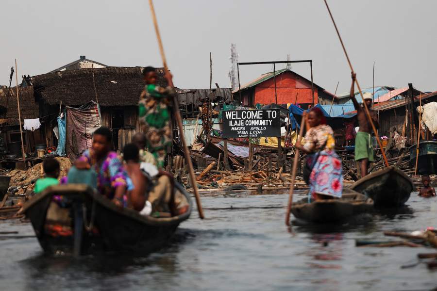 People evacuate, as authorities burn leftover structures in the Makoko riverine community in Lagos, Nigeria, January 25, 2026. Officials are removing structures, including homes and schools, near power lines, in a wider push to recover lagoon side land from the historic fishing community often called the "Venice of Nigeria." REUTERS/Sodiq Adelakun