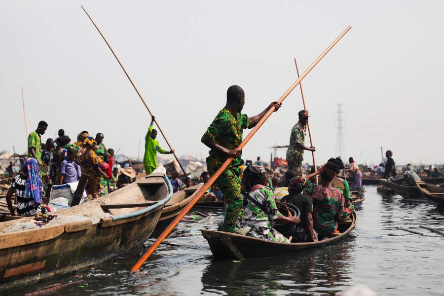 People evacuate, as authorities burn leftover structures in the Makoko riverine community in Lagos, Nigeria, January 25, 2026. Officials are removing structures, including homes and schools, near power lines, in a wider push to recover lagoon side land from the historic fishing community often called the "Venice of Nigeria." REUTERS/Sodiq Adelakun