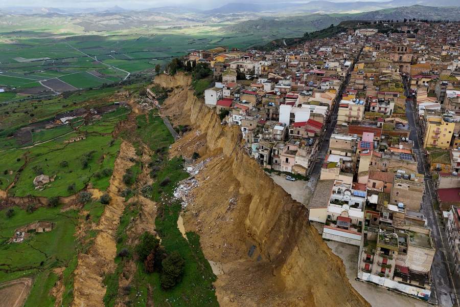 A drone view shows houses perched along the edge of a cliff after a landslide in Niscemi, Sicily, Italy, January 30, 2026. REUTERS/Fatos Bytyci TPX IMAGES
