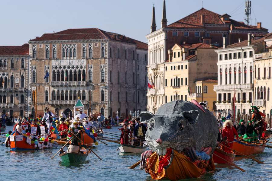 A boat carries a "Pantegana", the big rat, as revellers row during the masquerade parade on the Grand Canal during the Venice Carnival, in Venice, Italy, February 1